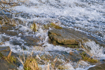 Fototapeta na wymiar waterfall, foaming, bubbling flowing water, nature background photo