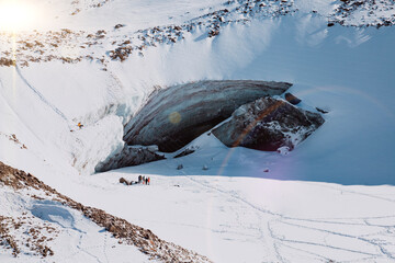 Beautiful ice cave in glacier. Winter mountain landscape.