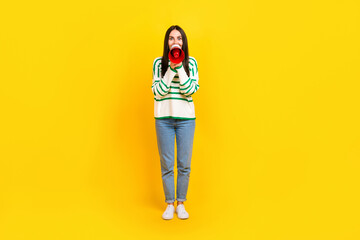 Full length photo of astonished excited positive lady wear stylish striped clothes share special offer isolated on yellow color background