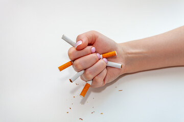 The broken cigarette on hand. Winning with addicted nicotine problems, stop smoking