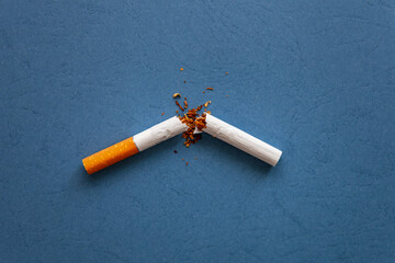 A broken cigarette with scattered tobacco for quit smoking concept