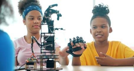 African black teenager students learning about robotic arm school, Technology and Innovation concept