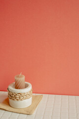 Candle holder on white table. pink wall background. cozy home decor