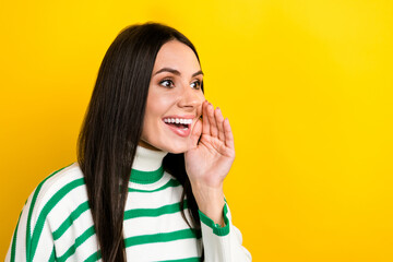 Photo of adorable excited woman wear striped sweater arm lip screaming empty space isolated yellow color background