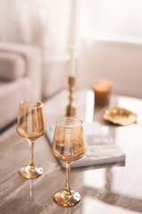 Beautiful golden-colored glass glasses on the coffee table