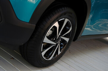 Fototapeta na wymiar car cover, rubber and new car tire. blue brand car