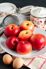 still life with apples spread out on a plate kitchen towel and flour