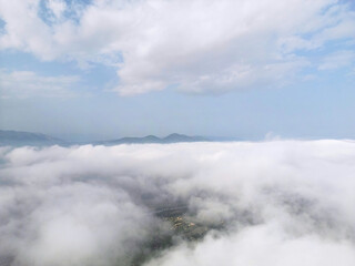 Flying above the clouds on drone.Drone soars through thick clouds, revealing majestic mountain silhouettes. Calp, Alicante, Spain