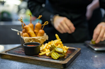 chef cookind corn dog on restaurant kitchen