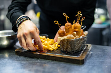 chef cookind corn dog on restaurant kitchen