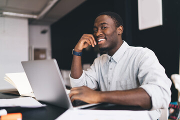 Fototapeta na wymiar Cheerful black man having online lesson
