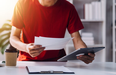 Financial analysts analyze business financial reports on a digital tablet planning investment...