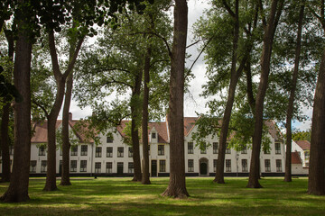Fototapeta na wymiar Flemish and ornate architecture of idyllic Bruges with garden park, Flanders, Belgium