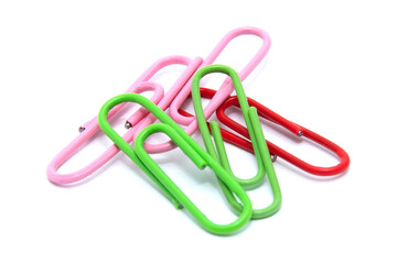 Multicolored paper clips lie isolated on a white background, stationery