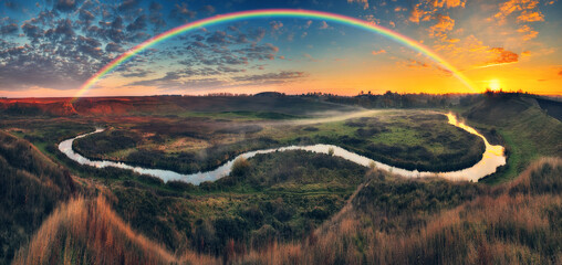 Amazing rainbow over the small rural river. autumn morning. nature of Ukraine


