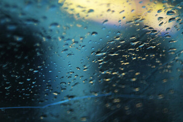 Raindrops on car window. blurred water drops on the glass, cold weather