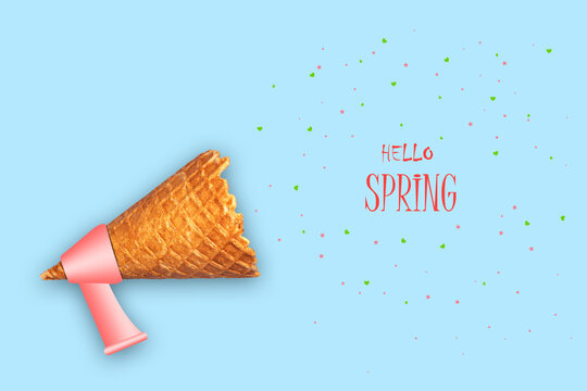 Ice cream cone, megaphone, and the words Hello spring. Blue background. The concept of the beginning of spring. Abstraction.aBckground