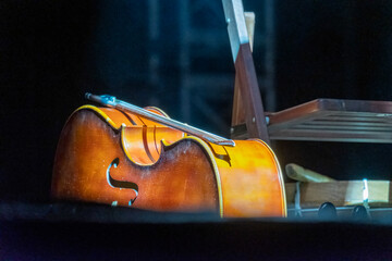 A double bass on stage with lighting. During the frenetic rustle of pre-show sound checks, this...