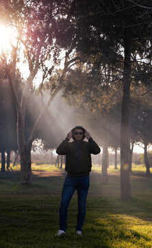 A man in forest. Sun shines. Fresh air and active lifestyle concept photo.