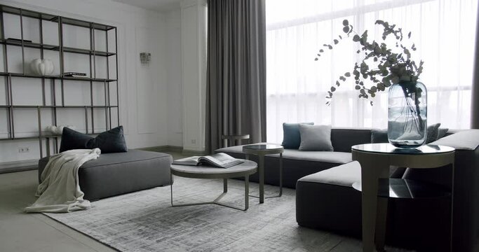 Luxury Modern House Interior With Corner Sofa round table. Modern contemporary Minimalist living room with grey furniture. Minimalist Home Interior. Cozy Modern Furniture Design. Luxury Elegant Room