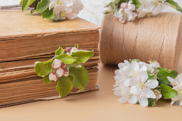 Obraz na płótnie Canvas Blossom apple twigs with vintage books. Spring still life composition
