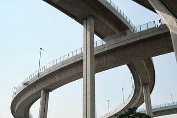 Elevated expressway during a sunny day .  highway overpass against blue sky .  Motorway viaduct...