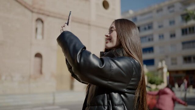 Young beautiful hispanic woman smiling confident make video by the smartphone at park