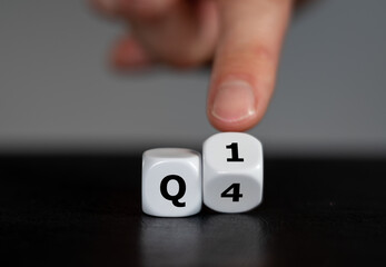 Symbol for the 1st Quarter of the year. Hand turns dice and changes the expression Q4 to Q1.