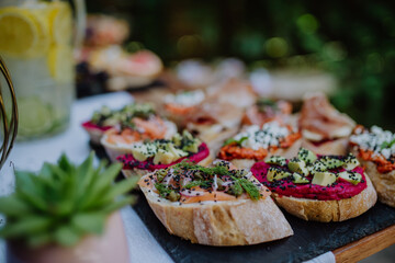 Dessert buffet at small wedding reception outside in the backyard.