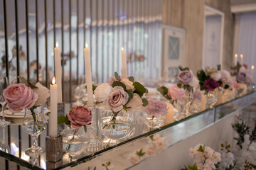 Amazing wedding table decoration with flowers and candles.