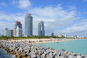 View of skyscrapers, South Pointe Park Pier and South Beach with sunbathers enjoying sun, beach and Atlantic Ocean. Miami, Florida