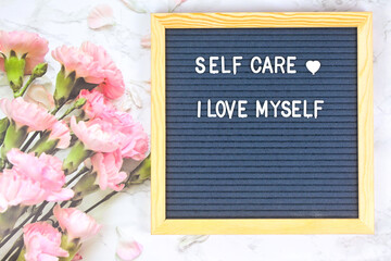 Grey letter board with phrase Self care, I am loved. Self love, Mindfulness lifestyle, mental...