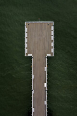 wooden pier on the background of green water