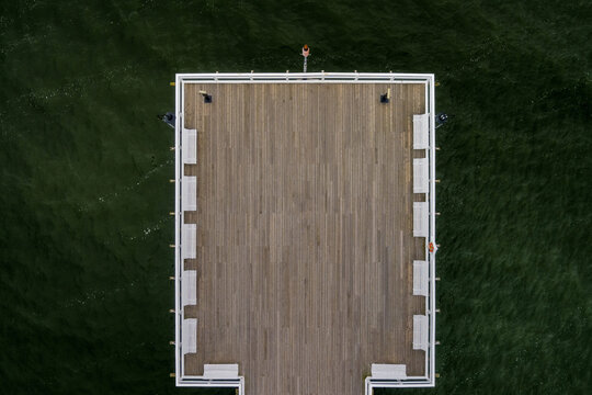 Fototapeta wooden pier on the background of green water