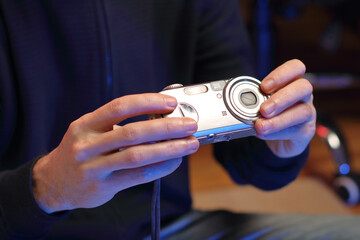 a person holds an old compact camera