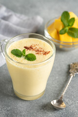 Lassi mango. Traditional Indian drink, gray background. Side view, selective focus.