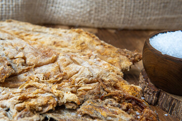 Close-up of salted cod next to grains of salt. Ingredient for fanesca, traditional food from Ecuador in Holy Week