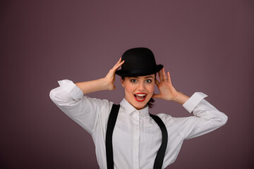 Portrait of happy young woman in hat, studio shoot.