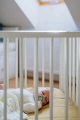 High angle view of little baby in little bed.