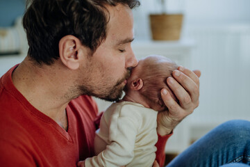 Close-up of father kissing his little son.
