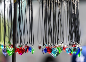 Pendants made of colored glass hanging on thongs.