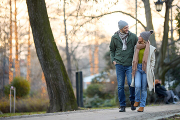 Embraced romantic couple enjoying a walk in the park