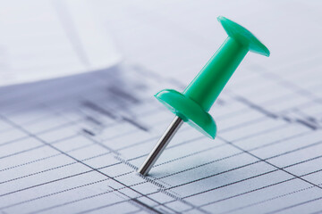 Marking financial chart by pins.Share listing and checking financial chart. Concept of banking, financial report and financial audit.