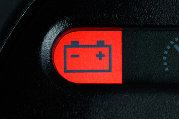 Fototapeta premium Close-up of the battery charge indicator light on the dashboard of the car. The car battery indicator on the dashboard warns of problems. Maintenance required. 