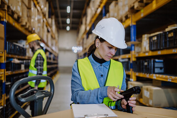 Warehouse female worker checking up stuff in a warehouse.
