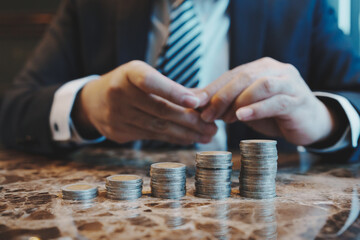 Close up of young business man and digital number of stock market background to represent...