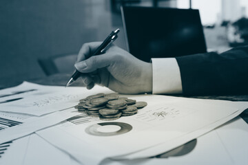 Close up of young business man and digital number of stock market background to represent...