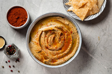Traditional arabian eggplant dip baba ganoush with herbs and smoked paprika on light background. Eggplant hummus. Babaganush or eggplant caviar. Baked eggplant. Turkish eggplant dip