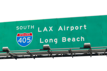 LAX Airport and Long Beach overhead freeway sign on Interstate 405 with cut out sky.