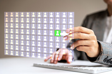 Human resources specialist working with digital database of employee marking high potential...